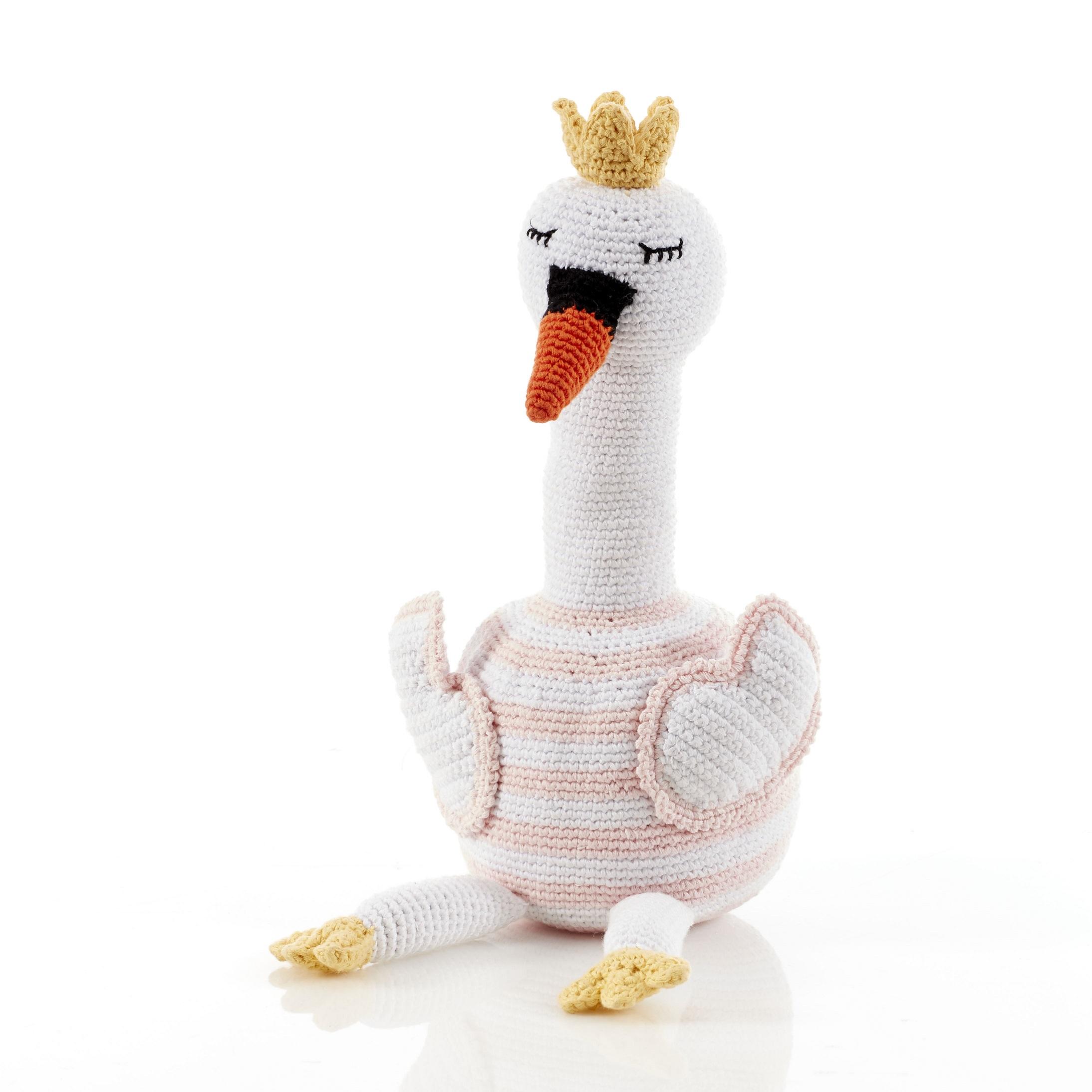 Large white crochet swan soft toy with pink and white stripe body, orange beak and golden crown on its head